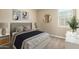 Charming bedroom with a queen bed, plush bedding, soft lighting, and stylish decorative accents at 41290 W Ganley Way, Maricopa, AZ 85138