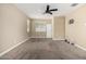 Carpeted bedroom with neutral paint, ceiling fan, and a double door closet at 41290 W Ganley Way, Maricopa, AZ 85138