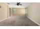 Open bedroom features neutral tones, carpeted floors, and a ceiling fan at 41290 W Ganley Way, Maricopa, AZ 85138