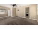 Large bedroom features neutral paint, carpet flooring, ceiling fan and an ensuite bathroom at 41290 W Ganley Way, Maricopa, AZ 85138