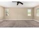Spacious bedroom with neutral paint, carpet flooring, and plenty of natural light at 41290 W Ganley Way, Maricopa, AZ 85138
