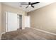 Bedroom with sliding closet door, and a ceiling fan for added comfort at 41290 W Ganley Way, Maricopa, AZ 85138