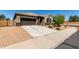 Inviting single-level home featuring desert landscaping, a spacious driveway, and a charming front entrance at 41290 W Ganley Way, Maricopa, AZ 85138