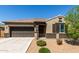 Charming single-story home with a two-car garage and desert landscaping for low maintenance at 41290 W Ganley Way, Maricopa, AZ 85138