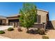 Attractive home featuring a two-car garage, tidy desert landscaping, and a cozy entrance at 41290 W Ganley Way, Maricopa, AZ 85138