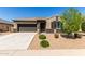 Beautiful single-Gathering home with desert landscaping, a two-car garage, and a well-maintained lawn at 41290 W Ganley Way, Maricopa, AZ 85138