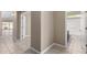 Hallway with tile flooring leads to an open living area and a bathroom with vanity at 41290 W Ganley Way, Maricopa, AZ 85138