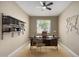 Bright home office features a modern desk, ample shelving, and a comfortable chair for remote work at 41290 W Ganley Way, Maricopa, AZ 85138