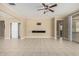 Open living room features neutral paint, carpet flooring, and plenty of natural light at 41290 W Ganley Way, Maricopa, AZ 85138