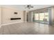 Living room with tile floors, ceiling fan, and access to the backyard through sliding glass doors at 41290 W Ganley Way, Maricopa, AZ 85138