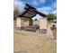Community picnic shelter featuring brick pillars, stone accents, a bench, picnic table, and a barbecue grill at 41290 W Ganley Way, Maricopa, AZ 85138