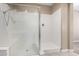 Modern walk-in shower with clear glass doors and a built-in bench at 41290 W Ganley Way, Maricopa, AZ 85138