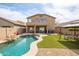 Backyard with private pool, artificial turf, and view of the home's exterior at 42410 N 46Th Ln, Phoenix, AZ 85086
