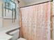 Charming bathroom with pink flower shower curtain and hanging plant at 42410 N 46Th Ln, Phoenix, AZ 85086