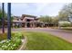 Beautifully landscaped clubhouse featuring lush green lawn and colorful flowerbeds at 42410 N 46Th Ln, Phoenix, AZ 85086