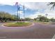Well-manicured roundabout with flag poles leading to a community building at 42410 N 46Th Ln, Phoenix, AZ 85086