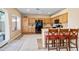 Bright kitchen featuring wood cabinetry, tile floors, and a breakfast bar at 42410 N 46Th Ln, Phoenix, AZ 85086