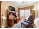 Comfortable office with wooden desk, chair, decorative rug, and natural light creating a welcoming workspace at 42410 N 46Th Ln, Phoenix, AZ 85086