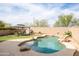 Serene backyard showcasing a private pool with rock features and an inviting ambiance at 42410 N 46Th Ln, Phoenix, AZ 85086