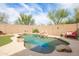 Backyard pool with rock waterfall feature surrounded by desert landscaping at 42410 N 46Th Ln, Phoenix, AZ 85086