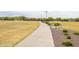 Scenic walkway with seating in a park, next to soccer fields with goals for community activities at 42410 N 46Th Ln, Phoenix, AZ 85086