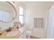 Bathroom with granite countertop, round mirror, and a shower with curtain at 4670 W Linda Ln, Chandler, AZ 85226