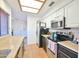 Bright kitchen with tile floors, stainless steel appliances, white cabinets, and light countertops at 4670 W Linda Ln, Chandler, AZ 85226