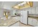Well-lit kitchen boasts granite countertops and modern white appliances at 5038 E Morning Star Dr, Phoenix, AZ 85044