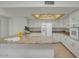 Bright and airy kitchen featuring granite countertops, white cabinetry, and a skylight at 5038 E Morning Star Dr, Phoenix, AZ 85044