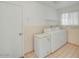 Bright laundry room with tile flooring, a washer, a dryer, and a chest freezer offers convenience at 5038 E Morning Star Dr, Phoenix, AZ 85044