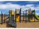 Modern playground with slides, climbing structures, and soft ground cover offering a safe play area at 5818 W Sunrise Dr, Laveen, AZ 85339