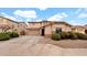 Charming home featuring a well-manicured lawn, a two-car garage and a driveway in a residential area at 6818 W St Catherine Ave, Laveen, AZ 85339