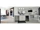 Modern kitchen island featuring sink, dishwasher, wine cooler, adjacent to dining room and a staircase at 6818 W St Catherine Ave, Laveen, AZ 85339