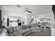 Open-concept living area with kitchen view, fireplace, ceiling fan, and comfortable seating with lots of natural light at 6818 W St Catherine Ave, Laveen, AZ 85339