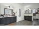 Spacious main bathroom featuring dual sinks, modern lighting fixtures, and a walk-in closet at 6818 W St Catherine Ave, Laveen, AZ 85339