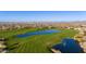 Overhead view showcasing community golf course, serene lakes, lush greenery, and mountain views at 7242 E Tyndall St, Mesa, AZ 85207