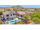 Aerial view of home and community highlighting the backyard pool, patio, mountain views and desert landscaping at 7242 E Tyndall St, Mesa, AZ 85207
