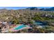 Aerial view of community amenities with a swimming pool, tennis courts, and desert mountain views at 7242 E Tyndall St, Mesa, AZ 85207