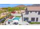 Gorgeous backyard with a sparkling pool, hot tub, lounge chairs, putting green and outdoor dining area at 7242 E Tyndall St, Mesa, AZ 85207