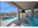 Stunning backyard oasis with a sparkling pool, covered patio, lounge chairs, and lush landscaping at 7242 E Tyndall St, Mesa, AZ 85207