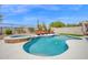 Beautiful backyard featuring a pool, spa, lounge seating, and desert landscaping at 7242 E Tyndall St, Mesa, AZ 85207