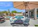 Inviting backyard featuring a pool, spa, outdoor dining area, fire pit, and lounge chairs for relaxing at 7242 E Tyndall St, Mesa, AZ 85207