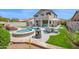 Expansive backyard with a pool, spa, outdoor seating, a fire pit, and lush landscaping at 7242 E Tyndall St, Mesa, AZ 85207