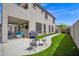 This patio features outdoor seating, a grill, and a view of the landscaped backyard with artificial turf at 7242 E Tyndall St, Mesa, AZ 85207