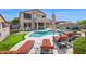 Resort style backyard features a pool, hot tub, covered patio, putting green and lounge seating at 7242 E Tyndall St, Mesa, AZ 85207