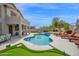 Backyard retreat with a pool, hot tub, lush lawn, lounge seating and covered patio area at 7242 E Tyndall St, Mesa, AZ 85207