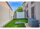 Backyard with an enclosed putting green, artificial grass and a patio at 7242 E Tyndall St, Mesa, AZ 85207