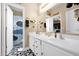 Stylish bathroom featuring a double sink vanity, modern fixtures, and bold black and white patterned flooring at 7242 E Tyndall St, Mesa, AZ 85207