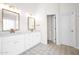 Bright bathroom with double vanities, elegant mirrors, and patterned tile flooring, blending style and functionality at 7242 E Tyndall St, Mesa, AZ 85207