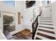 Bright foyer featuring hardwood floors, high ceilings, and a staircase with wood and white risers at 7242 E Tyndall St, Mesa, AZ 85207